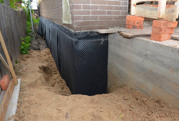 Happy homeowners after waterproofing job in Clark